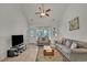 A cozy living room with neutral tones, wood-look floors, and a ceiling fan, ideal for entertaining at 101 Culpepper Way # 1007, Myrtle Beach, SC 29579