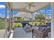 Cozy screened porch with blue seating, rug, and a view of the landscaped yard at 101 Culpepper Way # 1007, Myrtle Beach, SC 29579