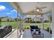 Enjoy views from this screened porch furnished with wicker seating, overlooking lush landscaping at 101 Culpepper Way # 1007, Myrtle Beach, SC 29579