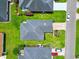 Aerial view of a home with a gray roof, green lawn, and mature landscaping in a desirable neighborhood at 10106 Duval Dr., Murrells Inlet, SC 29576