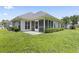 Well maintained backyard with a screened in patio and lush green grass at 10106 Duval Dr., Murrells Inlet, SC 29576