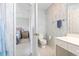 View of the half bathroom with floral wallpaper and white vanity next to bedroom at 10106 Duval Dr., Murrells Inlet, SC 29576