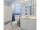 Bathroom with blue tile, tub-shower, white vanity, and window for natural light at 10106 Duval Dr., Murrells Inlet, SC 29576