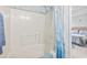 Bathroom features a shower/tub combo with blue shower curtain and access to the bedroom at 10106 Duval Dr., Murrells Inlet, SC 29576