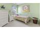 Bedroom with light green walls, twin bed, white dresser, natural light, and decorative wall art at 10106 Duval Dr., Murrells Inlet, SC 29576