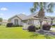 Charming single-story home with a well-kept lawn and attractive landscaping with a beautiful palm tree at 10106 Duval Dr., Murrells Inlet, SC 29576