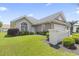 Well-maintained single-story home with a manicured lawn and beautiful shrubbery at 10106 Duval Dr., Murrells Inlet, SC 29576