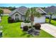Well-maintained single-story home with a two-car garage and lush landscaping, including a mature palm tree at 10106 Duval Dr., Murrells Inlet, SC 29576
