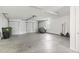 Spacious two car garage with white doors, concrete floors, and overhead lighting, perfect for parking and storage at 10106 Duval Dr., Murrells Inlet, SC 29576