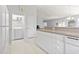 Bright kitchen area with white cabinets and appliances, adjacent laundry area, and access to dining at 10106 Duval Dr., Murrells Inlet, SC 29576