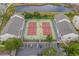 Aerial view of condos complex and tennis courts with parking and surrounding landscape at 1100 Possum Trot Rd. # B202, North Myrtle Beach, SC 29582
