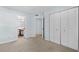 Bedroom with neutral carpet flooring, pale blue walls and closet space at 1100 Possum Trot Rd. # B202, North Myrtle Beach, SC 29582