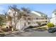 Exterior view of a three-story building with balconies and parking area including handicap parking at 1100 Possum Trot Rd. # B202, North Myrtle Beach, SC 29582