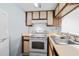 Functional kitchen featuring an electric range, ample cabinetry, and a bright white refrigerator at 1100 Possum Trot Rd. # B202, North Myrtle Beach, SC 29582