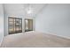 Bright living room with two sliding glass doors and neutral carpet, offering plenty of natural light at 1100 Possum Trot Rd. # B202, North Myrtle Beach, SC 29582