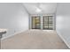 Bright living room with two sliding glass doors and neutral carpet, offering plenty of natural light at 1100 Possum Trot Rd. # B202, North Myrtle Beach, SC 29582