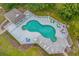Aerial view of a community pool with lounge chairs, tables and a decorative fence at 1100 Possum Trot Rd. # B202, North Myrtle Beach, SC 29582