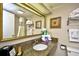Well-lit bathroom featuring a granite vanity, mirror, towels, and artwork at 1105 S Ocean Blvd. # 1144, Myrtle Beach, SC 29577