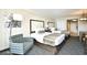 Cozy bedroom featuring two beds with decorative pillows, a striped chair, and carpeted floors at 1105 S Ocean Blvd. # 1144, Myrtle Beach, SC 29577