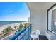 Balcony showcasing an oceanfront view, palm trees, a pool, and comfortable seating at 1105 S Ocean Blvd. # 420, Myrtle Beach, SC 29577