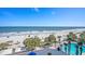 Expansive beach view with blue umbrellas, palm trees, and a pool at 1105 S Ocean Blvd. # 420, Myrtle Beach, SC 29577