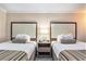 Bedroom featuring two beds, a nightstand, and comfortable pillows at 1105 S Ocean Blvd. # 420, Myrtle Beach, SC 29577