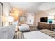 Bedroom featuring two beds, a TV, and a bureau with lamp at 1105 S Ocean Blvd. # 420, Myrtle Beach, SC 29577