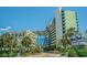 Attractive view of the Coral Beach Resort with its lush landscaping and blue accents at 1105 S Ocean Blvd. # 420, Myrtle Beach, SC 29577