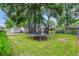Backyard features a trampoline, grassy lawn, storage shed, and mature trees at 1108 Chicora Blvd., Conway, SC 29526