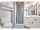 Bathroom featuring wallpaper, framed mirror, vanity, a glass shower and commode at 1108 Chicora Blvd., Conway, SC 29526