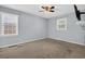 Bedroom featuring neutral walls and carpets, ceiling fan, and two windows at 1108 Chicora Blvd., Conway, SC 29526