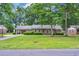 Charming single-story brick home featuring a well-manicured lawn and mature shade trees at 1108 Chicora Blvd., Conway, SC 29526