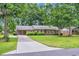 Well-maintained brick home with a long driveway and basketball hoop on a lush green lawn at 1108 Chicora Blvd., Conway, SC 29526