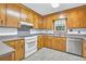Classic kitchen featuring wood cabinets, updated appliances, and lots of natural light at 1108 Chicora Blvd., Conway, SC 29526