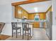 Eat-in kitchen with ample wood cabinets, stainless appliances, and a view to the living area at 1108 Chicora Blvd., Conway, SC 29526