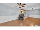 Open-concept living area with wood-look flooring, a ceiling fan and views into the adjacent kitchen at 1108 Chicora Blvd., Conway, SC 29526