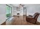 Living room with built-in shelving, a fireplace, wood floors, and sliding glass doors to the yard at 1108 Chicora Blvd., Conway, SC 29526