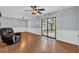 Cozy living room with wood-look flooring, ceiling fan and sliding glass doors to the backyard at 1108 Chicora Blvd., Conway, SC 29526