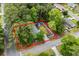 Aerial view of property showcasing the home, yard, fence, and surrounding mature trees at 1111 King St., Myrtle Beach, SC 29577