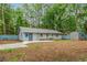 Backyard view of home, showing the patio, shed, blue fence, and partial brick exterior at 1111 King St., Myrtle Beach, SC 29577
