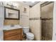 Updated bathroom features a stylish vanity, toilet, and tiled walk-in shower with pebble floor at 1111 King St., Myrtle Beach, SC 29577