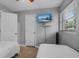 Bright bedroom featuring twin beds, neutral color palette and a mounted TV at 1111 King St., Myrtle Beach, SC 29577