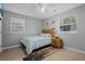 This bright bedroom features a cozy bed, natural light, and neutral color scheme at 1111 King St., Myrtle Beach, SC 29577