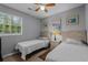 This bedroom includes twin beds, ceiling fan, and closet in a neutral color palette at 1111 King St., Myrtle Beach, SC 29577
