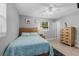 Cozy bedroom with natural light from the windows, light walls and light wooden furniture at 1111 King St., Myrtle Beach, SC 29577