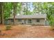 Charming single-story brick home with blue shutters and a well-maintained front yard surrounded by mature trees at 1111 King St., Myrtle Beach, SC 29577