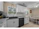 Well-lit kitchen featuring white cabinets, stainless steel appliances, geometric backsplash and dining area at 1111 King St., Myrtle Beach, SC 29577