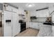 Well-equipped kitchen showcases white cabinetry, stainless steel microwave, and patterned backsplash at 1111 King St., Myrtle Beach, SC 29577
