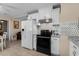 Updated kitchen featuring stainless steel appliances and white cabinets adjacent to living space at 1111 King St., Myrtle Beach, SC 29577