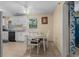 Cozy kitchen features modern white cabinets, geometric backsplash and dining table with four chairs at 1111 King St., Myrtle Beach, SC 29577